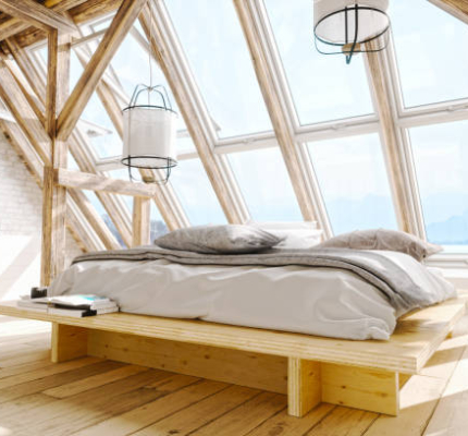 Interior of a Scandinavian style attic bedroom with beautiful sea and mountain view.